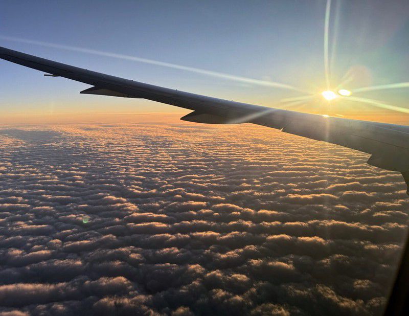 Sunrise from the plane window just before we descend through the cloud cover